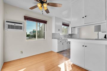 No. Hollywood apartment for rent - A kitchen with white cabinets and a ceiling fan.