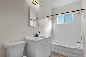 No. Hollywood apartment for rent - A white bathroom with a toilet, sink, and bathtub.