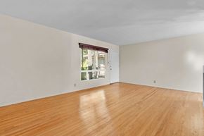 No. Hollywood apartment for rent - A room with wooden flooring and a window showing daylight outside.