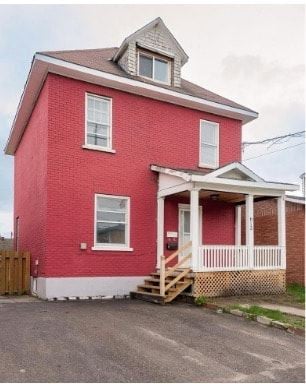 North Bay apartment for rent - A red brick house with a white porch.