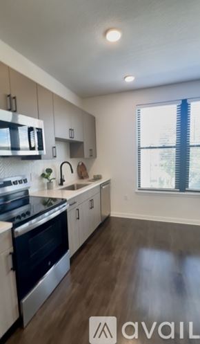 Tampa apartment for rent - A kitchen with a stove top oven and a window.