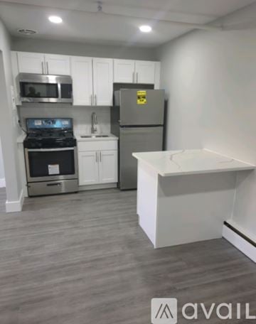 Keansburg apartment for rent - A kitchen with a stove, oven, refrigerator, and microwave.
