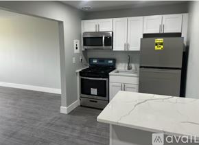 Keansburg apartment for rent - A kitchen with a refrigerator, oven, and microwave.
