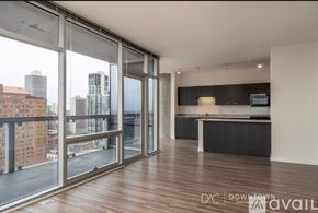 Chicago apartment for rent - A spacious room with a view of the cityscape outside the large windows.