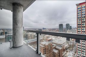 Chicago apartment for rent - A view from a high-rise building looking out over a cityscape.