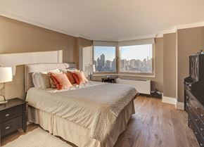 New York apartment for rent - a bedroom with a large bed and a window