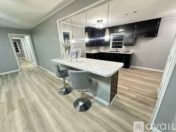 Meridian house for rent - A kitchen with a table and chairs in the middle of the room.