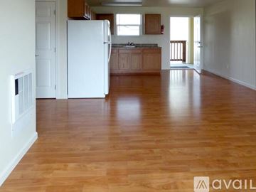 Arcata apartment for rent - A kitchen with a white refrigerator and wooden floors.