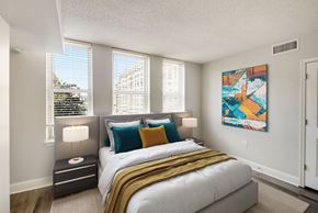 Washington apartment for rent - A bedroom with a large bed and a painting on the wall