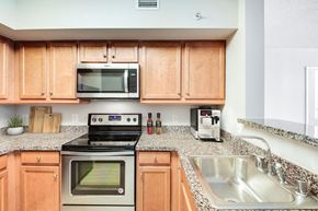 Washington apartment for rent - A kitchen with wooden cabinets and a stove top oven