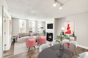 Washington apartment for rent - A living room with a grey table and pink chairs.