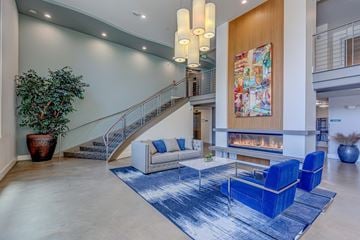 Seattle apartment for rent - a living room with blue chairs and a fireplace