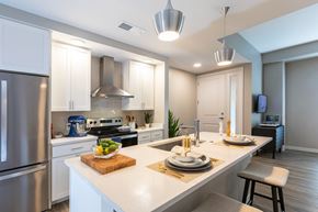 Columbus apartment for rent - A modern kitchen with a stainless steel refrigerator and a breakfast setting on the counter.