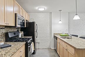Richmond apartment for rent - a kitchen with granite counter tops and black appliances