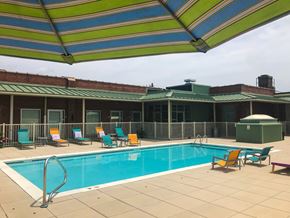 Richmond apartment for rent - a swimming pool with chairs and an umbrella next to a hotel pool