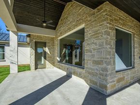 Horseshoe Bay house for rent - A modern house with a stone exterior and a large glass window.