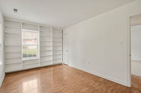 Glen Allen house for rent - A room with a window covered by white blinds and wooden flooring.