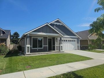 Coeur D'alene house for rent - A house with a grey roof and a white garage door.
