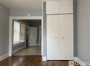 Ypsilanti apartment for rent - A bathroom with a toilet, sink, and mirror.