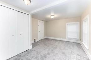 Ypsilanti apartment for rent - A bedroom with a grey carpet and white cupboards.