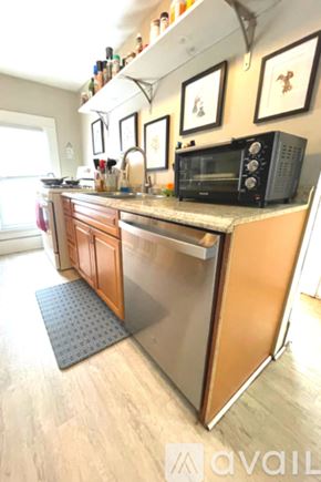 Ypsilanti apartment for rent - A kitchen with a black microwave on the counter.