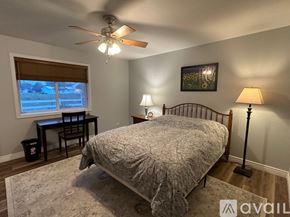 Weiser house for rent - A bedroom with a bed, desk, and window.