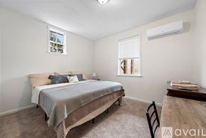 Winston-Salem apartment for rent - A bedroom with a bed, chair, and window.