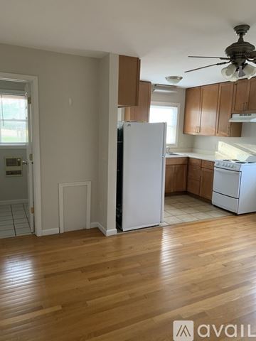 Bridgewater apartment for rent - A kitchen with a white refrigerator and wooden floors.