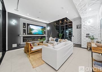 Los Angeles house for rent - A modern living room with a large television and comfortable seating.