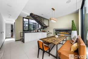 Los Angeles house for rent - A modern kitchen with a dining table and chairs.