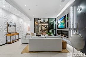 Los Angeles house for rent - A bedroom with a large bed and a balcony with glass doors.