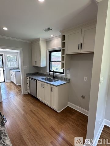 Memphis house for rent - A kitchen with white cabinets and a black countertop.