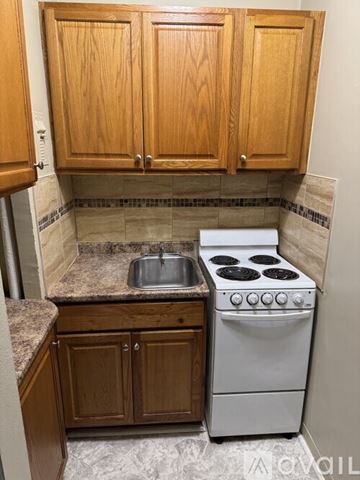 Wauwatosa apartment for rent - A kitchen with a white oven and sink.