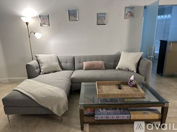 Miami Beach apartment for rent - A living room with a glass table and chairs.