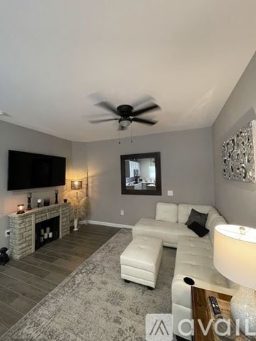 Buckeye apartment for rent - A living room with a white couch and a fireplace.