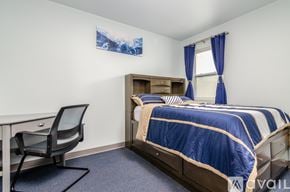 Johnson City apartment for rent - A bedroom with a bed, desk, and chair.