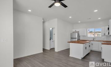 Buckeye apartment for rent - A spacious kitchen with white cabinets and a wooden countertop.