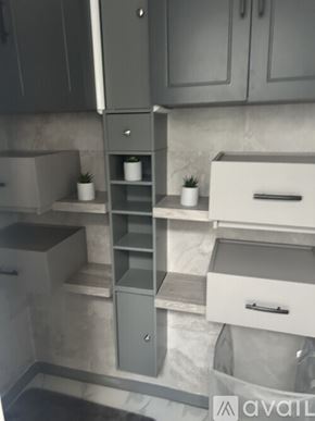 Signal Hill condo for rent - A kitchen with grey cabinets and a marble backsplash.