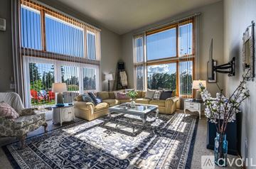 Bigfork house for rent - A living room with a sofa set, a coffee table, and a rug.