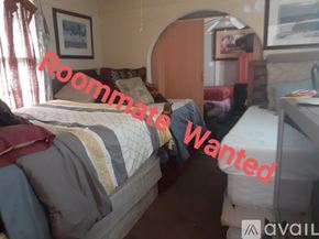 New Orleans apartment for rent - A bedroom with a bed, a desk, and a chair is available for rent.