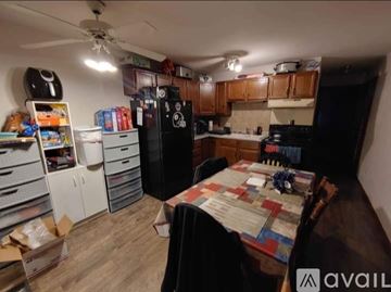 Sheboygan house for rent - A kitchen with a table and chairs in the middle of the room.