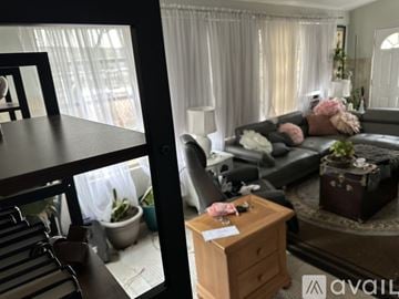 Manville apartment for rent - A living room with a grey couch and a wooden side table.