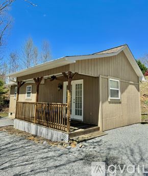 Marion house for rent - A small wooden house with a porch and a covered entrance.