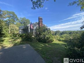 West Morris house for rent - A house with a chimney and an American flag on the front porch.
