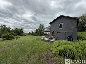 Litchfield house for rent - A house with a grey roof and a green lawn in front.