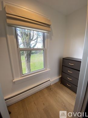 Litchfield house for rent - A window with a view of a tree and grass outside.