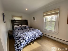 Litchfield house for rent - A bedroom with a bed, nightstand, and window.
