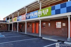 Denver apartment for rent - A building with a blue and white checkered awning.