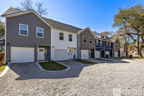 North Charleston townhouse for rent - A modern two-story house with a gravel driveway in front.
