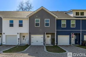 North Charleston townhouse for rent - A row of houses with garages and driveways.